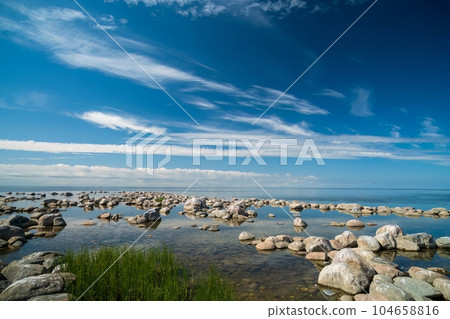 The rocky shore of the Baltic Sea. Beautiful sunny summer day, calm sea. Baltic Sea Estonia Kihnu Island. 104658816