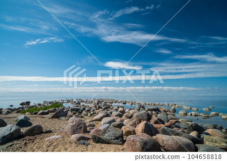 The rocky shore of the Baltic Sea. Beautiful sunny summer day, calm sea. Baltic Sea Estonia Kihnu Island. The rocky shore of the Baltic Sea. Beautiful sunny summer day, calm sea. Baltic Sea Estonia Kihnu Island. 104658818