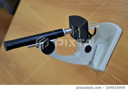 A school laboratory microscope. Laboratory with a microscope. A school laboratory microscope. Laboratory with a microscope. 104658949