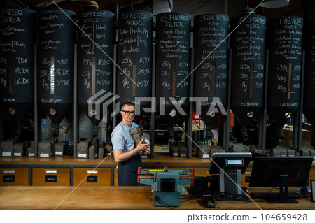 Barista holding pack of coffee in the hands in cafe. 104659428