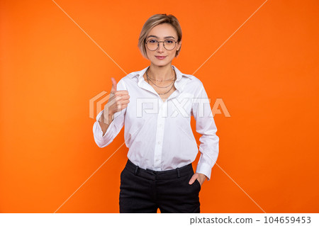 Attractive confident woman wearing white official style shirt showing thumb up Attractive confident woman wearing white official style shirt showing thumb up 104659453