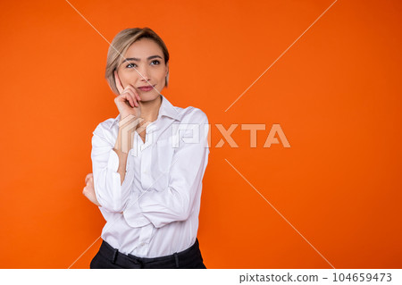 Pensive woman wearing white official style shirt thinking holding chin free space Pensive woman wearing white official style shirt thinking holding chin free space 104659473