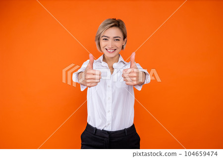 Positive woman wearing white official style shirt showing like gesture and smiling to camera Positive woman wearing white official style shirt showing like gesture and smiling to camera 104659474