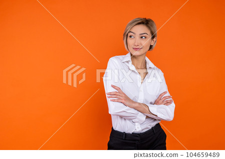 Confident woman wearing white official style shirt standing with crossed arms Confident woman wearing white official style shirt standing with crossed arms 104659489