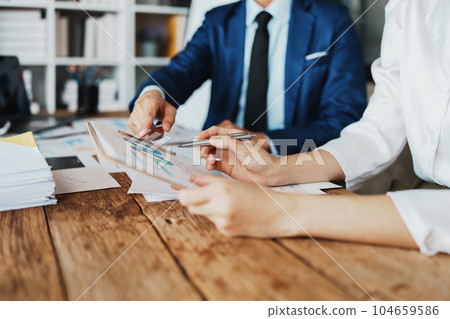 Asian business advisor meeting to analyze and discuss the situation on the financial report in the meeting room.Investment Consultant, Financial , teamwork ,brainstorming ,startup and accounting. 104659586