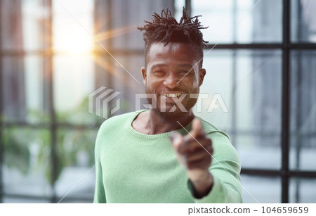Handsome businessman pointing his finger to the camera Handsome businessman pointing his finger to the camera 104659659