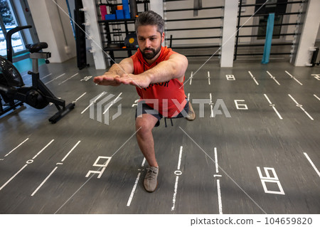 Athletic man warming up and stretching body before training fitness gym, body care. 104659820