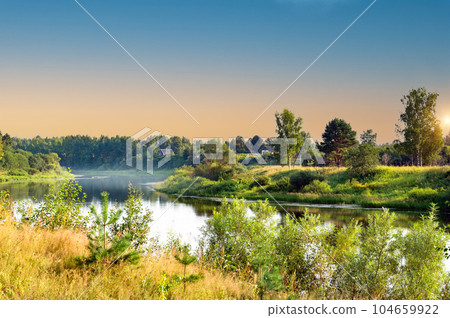 Beautiful summer landscape of meadows near the river and forest. The upper reaches of the Volga River in the Tver region of Russia. Picturesque rural landscape. Summer natural background. Photos from Beautiful summer landscape of meadows near the river and forest. The upper reaches of the Volga River in the Tver region of Russia. Picturesque rural landscape. Summer natural background. Photos from 104659922