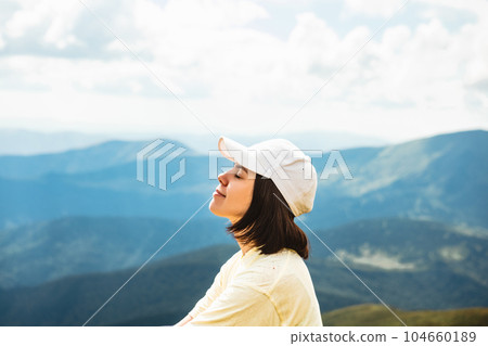 Woman on the top of a mountain 104660189