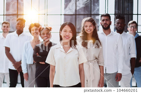 happy team of diverse corporate employees in the office lobby. 104660201