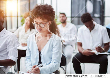 business people attending a seminar in board room. business people attending a seminar in board room. 104660350