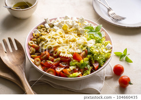 Pasta salad. Traditional Italian pasta salad with cherry tomatoes, olives, feta cheese, green cabbage. 104660435