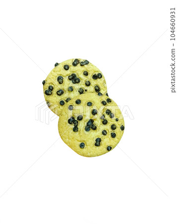 Yellow cookies covered with chocolate chips on a white background Yellow cookies covered with chocolate chips on a white background 104660931