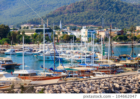 White yachts in the sea harbor of Kemer, Antalya province in Turkey. Kemer Marina on the Mediterranean sea White yachts in the sea harbor of Kemer, Antalya province in Turkey. Kemer Marina on the Mediterranean sea 104662047