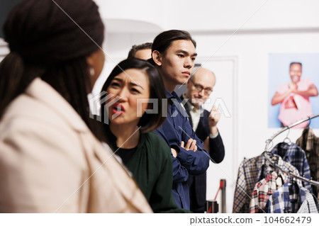 Angry rude diverse shoppers arguing while waiting in line at fashion store entrance for Black Friday sales. Diverse people customers lined up outside department fighting with each other Angry rude diverse shoppers arguing while waiting in line at fashion store entrance for Black Friday sales. Diverse people customers lined up outside department fighting with each other 104662479