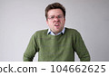 The angry European young man wearily looks. He is without strength and energy 104662625