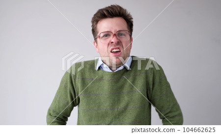 The angry European young man wearily looks. He is without strength and energy 104662625