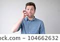 The young man is trying to keep a secret. he doesn't want to speak. 104662632