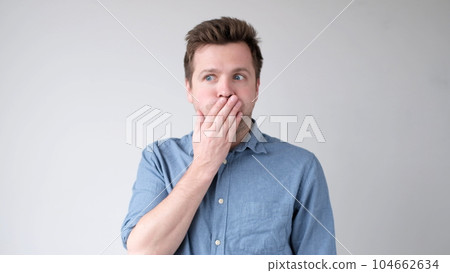 The young man is trying to keep a secret. he doesn't want to speak. The young man is trying to keep a secret. he doesn't want to speak. 104662634