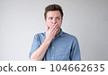 The young man is trying to keep a secret. he doesn't want to speak. 104662635