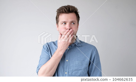 The young man is trying to keep a secret. he doesn't want to speak. 104662635