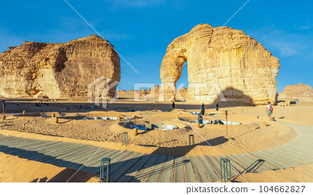 Walking tourist path and lounges at sandstone elephant rock erosion monolith standing in the desert, Al Ula, Saudi Arabia 104662827