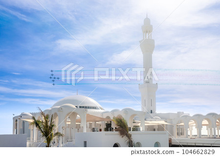 Fighter Jets Squadron with smoke traces over Alrahmah mosque, Jeddah, Saudi Arabia 104662829