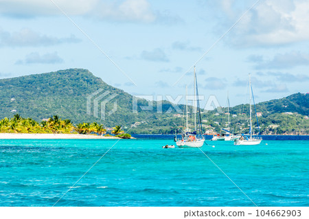 Turquoise sea and anchored yachts near Carriacou island, Grenada, Caribbean sea Turquoise sea and anchored yachts near Carriacou island, Grenada, Caribbean sea 104662903
