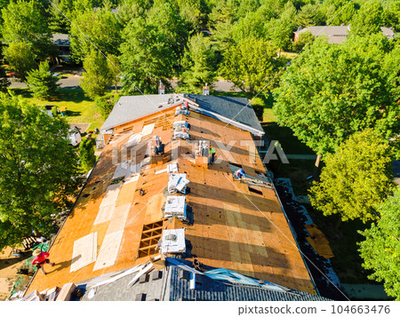During repair of apartment buildings roof, new shingles were installed and old ones were replaced plywood. 104663476