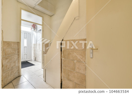 an open door in a room that has been stripped off and is being used as a place to hang something on the wall 104663584