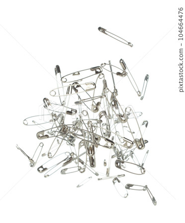 Safety Pin brooch pour fall down, explosion in air. Many safety pin mix size splash fly in group floating. White background isolated high speed shutter freeze motion 104664476