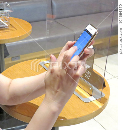 Hand to operate smartphone 104664570