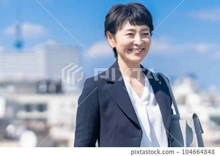 Portrait of a female manager in her 50s wearing a jacket Portrait of a female manager in her 50s wearing a jacket 104664848