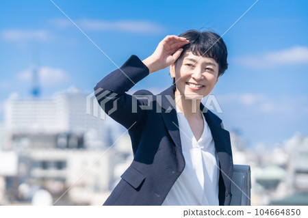 Portrait of a female manager in her 50s wearing a jacket Portrait of a female manager in her 50s wearing a jacket 104664850