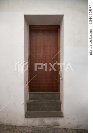 An old house in a romantic city. Colorful and beautiful gates made of wood. vintage door. An old house in a romantic city. Colorful and beautiful gates made of wood. vintage door. 104665974
