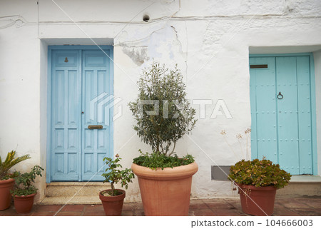 An old house in a romantic city. Colorful and beautiful gates made of wood. vintage door. An old house in a romantic city. Colorful and beautiful gates made of wood. vintage door. 104666003
