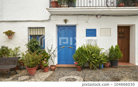 An old house in a romantic city. Colorful and beautiful gates made of wood. vintage door. An old house in a romantic city. Colorful and beautiful gates made of wood. vintage door. 104666030