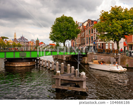 View of Catharijnebrug swing bridge over Spaarne with passing boats in Haarlem View of Catharijnebrug swing bridge over Spaarne with passing boats in Haarlem 104666186