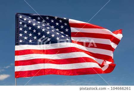 Large USA flag waving against sky Large USA flag waving against sky 104666261