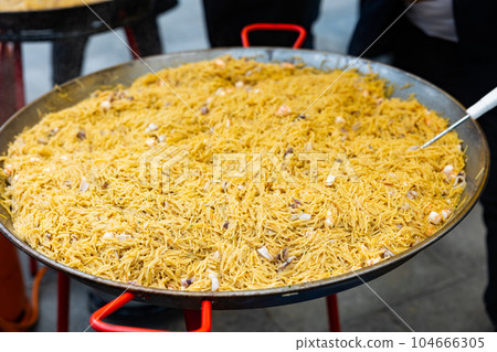 Cooking the Valencian dish Fideua de Marisco 104666305