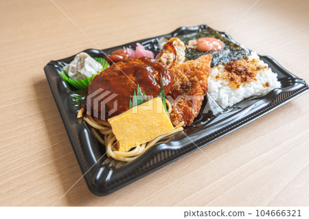 Japanese bento set lunch box of hamburger steak, seaweed on rice, fried fish and Japanese rolled omelet 104666321
