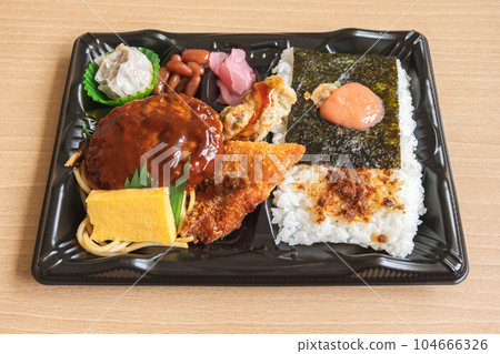 Japanese bento set lunch box of hamburger steak, seaweed on rice, fried fish and Japanese rolled omelet 104666326