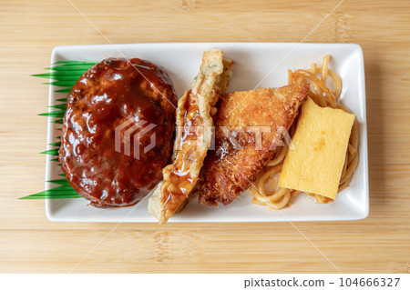 Japanese hamburger steak, fried fish and Japanese rolled omelet on white plate Japanese hamburger steak, fried fish and Japanese rolled omelet on white plate 104666327