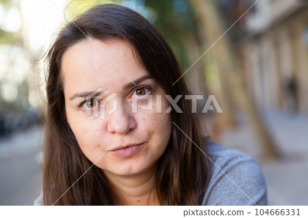 Closeup face of romantic girl walking through streets 104666331