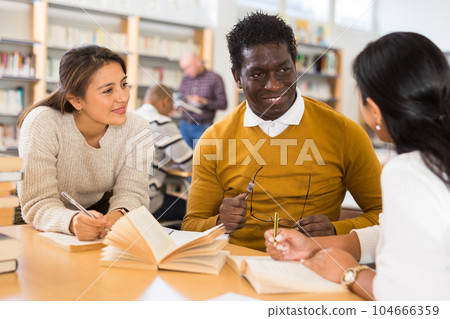 Group of adult people studying in library Group of adult people studying in library 104666359