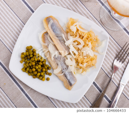 Salted herring fillet with pickled cabbage and green peas Salted herring fillet with pickled cabbage and green peas 104666433