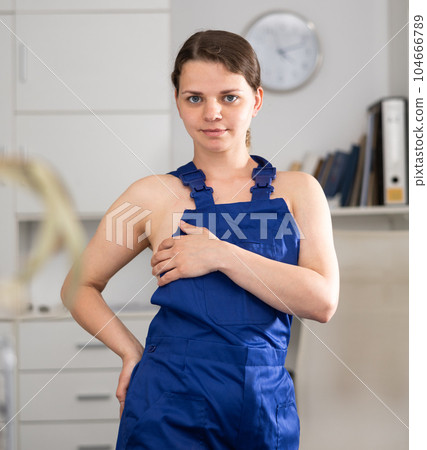 Waist-up portrait of seductive naked woman in overall in office Waist-up portrait of seductive naked woman in overall in office 104666789