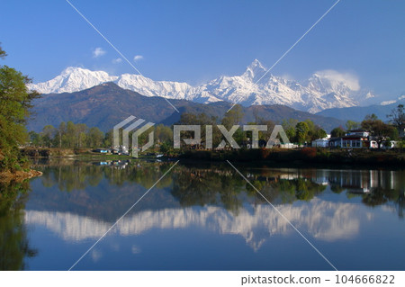Pokhara, Nepal in South Asia View of Machapuchare and Annapurna mountain range from the dam side and the water mirror of Fewa Lake 104666822