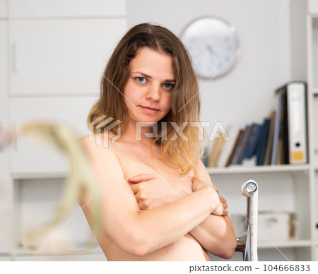 Portrait of naked woman standing in office Portrait of naked woman standing in office 104666833