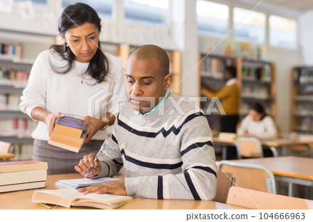 Adult people gaining skills at public library Adult people gaining skills at public library 104666963